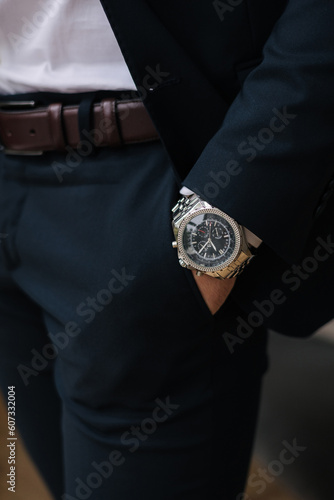 Close-up of male hand in pocket. Luxury watch on man's hand. Stylish look