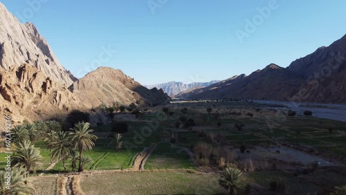 Aerial Flying Over Farmland Covered In Mountain Shadow In Khuzdar,  Balochistan. Dolly Forward photo