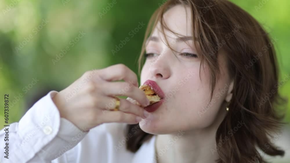 beautiful woman with red sexy lips appetizingly eats pizza on the terrace. The pleasure of food beautiful woman with red sexy lips appetizingly eats pizza on the terrace. The pleasure of food