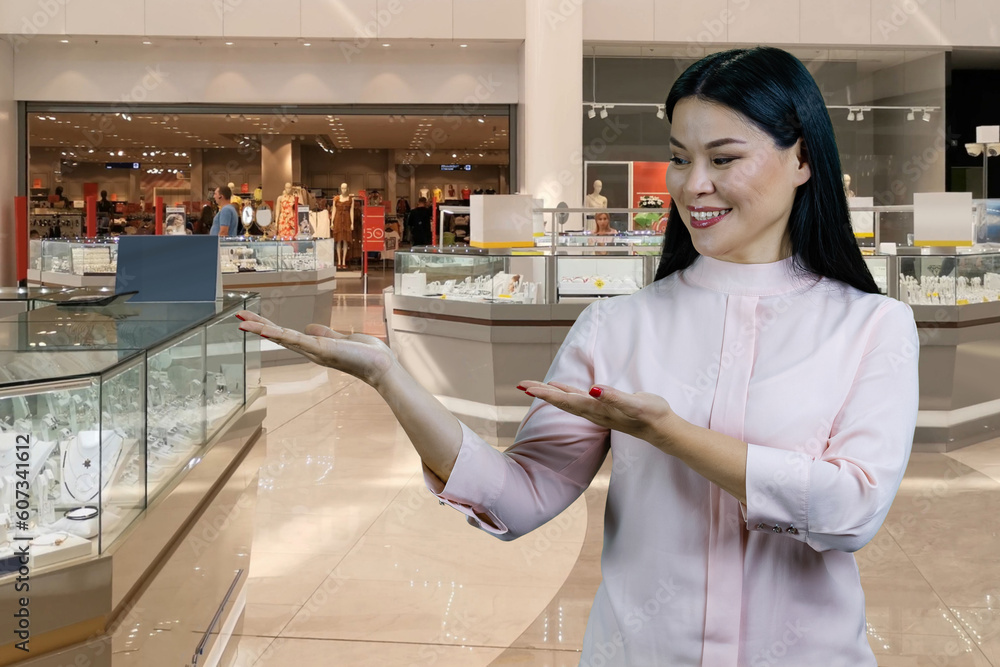 Happy smiling asian woman showing advertising copy space with both hands. Bijouterie boutique store in the background. Happy smiling asian woman showing advertising copy space with both hands. Bijouterie boutique store in the background.