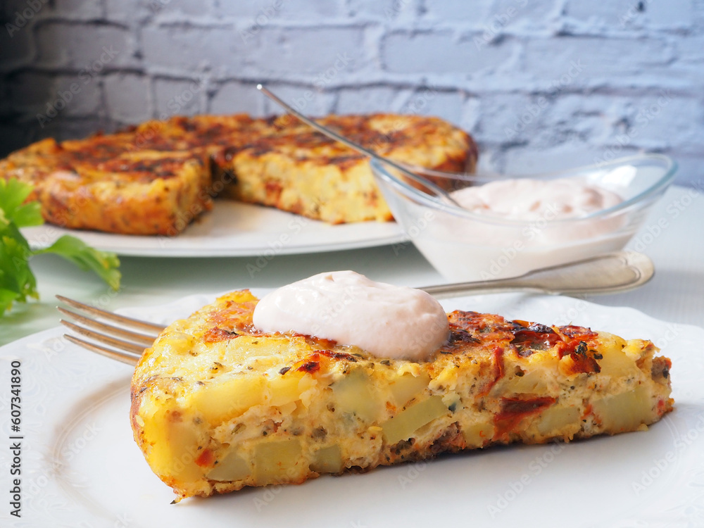 Spanish omelette with potatoes and Sun-Dried Tomatoes, Sauce, and Irresistible Slices in Focus