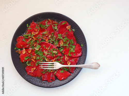 Red Piquillo Pepper with garlic chips, parsley photo