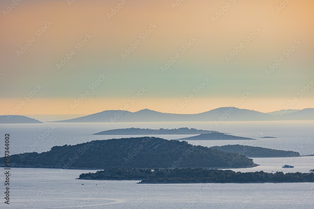 Beautiful scenery of mountains and cliffs in the Croatian sea at sunset