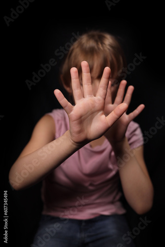 little girl defended against domestic violence, selective focus on black background © Michael