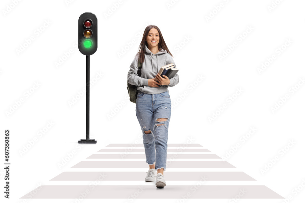 © Ljupco Smokovski - Full length portrait of a female student carrying books and walking on the street