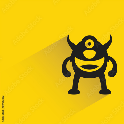 alien monster with shadow on yellow background