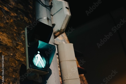 Low angle shot of a green light at the pedestrian crossing