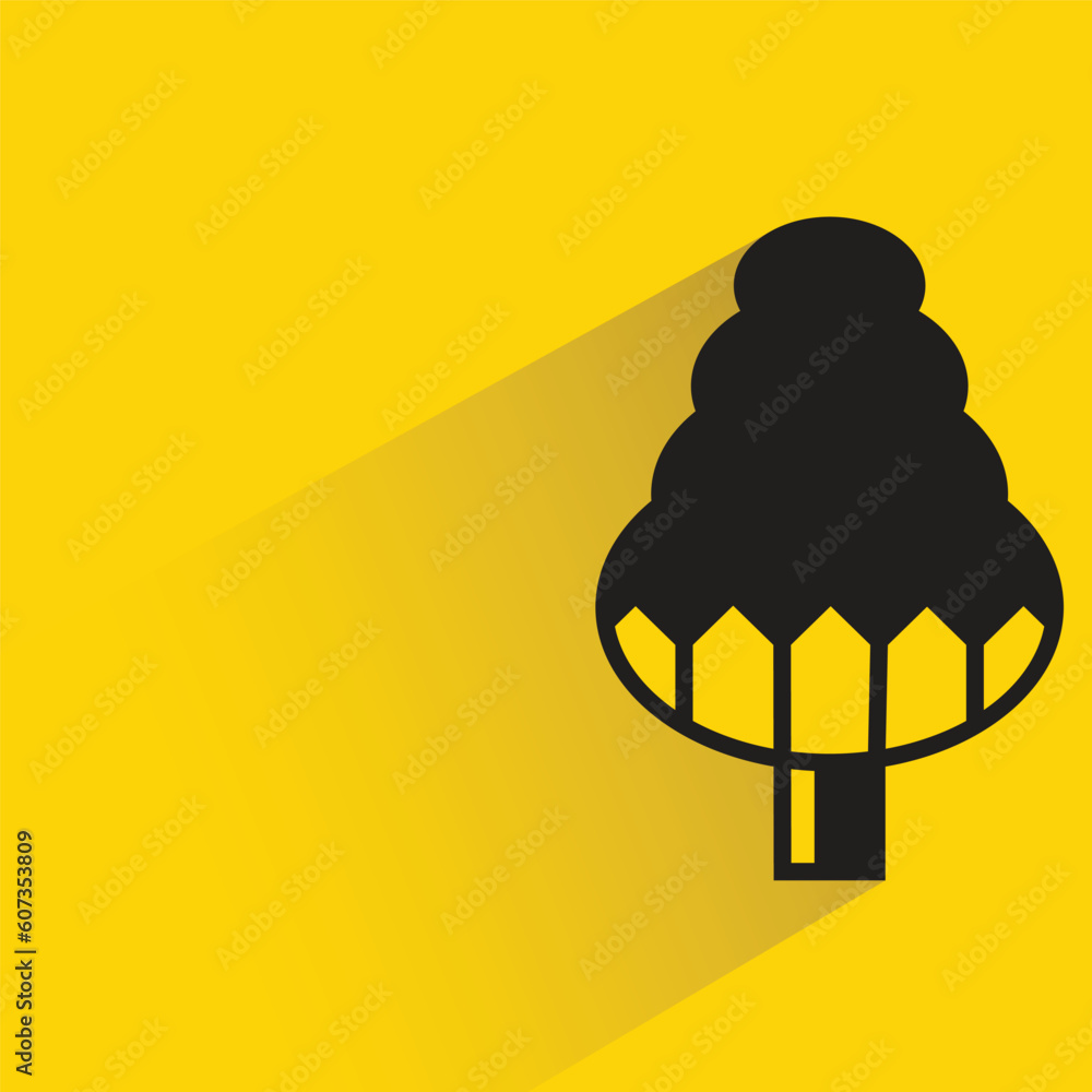 pine tree with shadow on yellow background