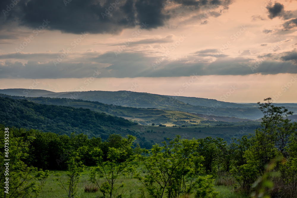 Wonderful summer landscape in mountains. Grassy field and rolling hills. Fruska Gora at sunset, Serbia