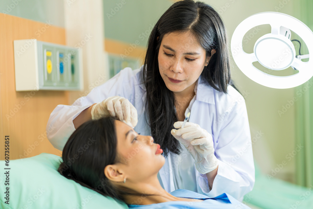 Asian woman consulting about Cosmetic surgeon and make Botox injections on face for beauty procedures. Plastic surgery in face of woman Asian woman consulting about Cosmetic surgeon and make Botox injections on face for beauty procedures. Plastic surgery in face of woman