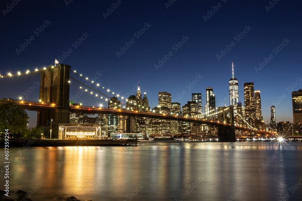 Scenic shot of the lights on the bridge and skyline of Manhattan in New York during nighttime