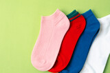 The Socks of different colors on green background.