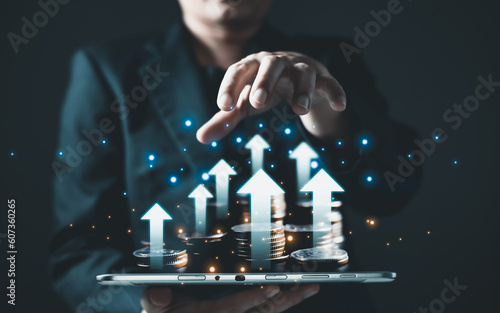 A person holding tablet and money coin to plan and analyze in e-business, the use of online digital network technology in growth business, buying and selling commerce online digital marketplace