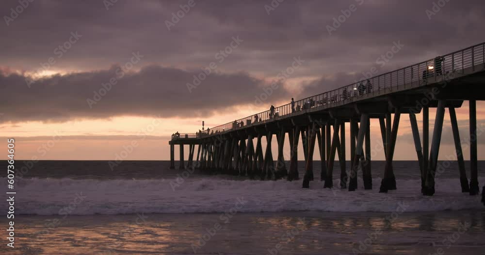 Golden sunset over the Pacific with pier and ocean waves Golden sunset over the Pacific with pier and ocean waves