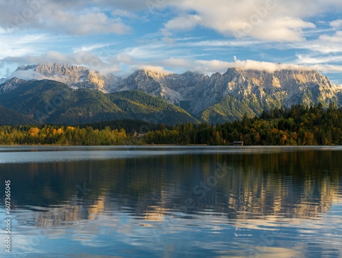 Beautiful view of a lake with mountains reflection on it © Paul Tyler/Wirestock Creators