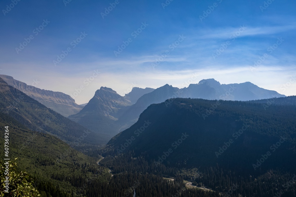 Scenic view of mountain forests during daytime in Glacier National Park, Montana Scenic view of mountain forests during daytime in Glacier National Park, Montana