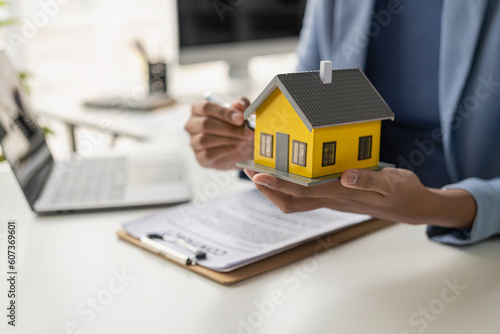 A real estate agent offers a house to a businessman who signs a deal. For home insurance consultants, real estate investments, property insurance...