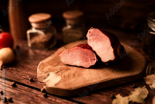 Close-up of fresh tasty meat on a wooden table with addition of fresh herbs and aromatic spices