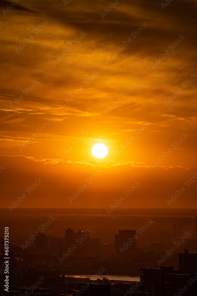 Vertical shot of a beautiful sunset sky over the buildings. Vertical shot of a beautiful sunset sky over the buildings.