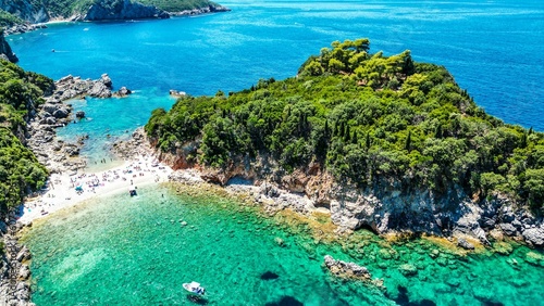 Aerial view lush green vegetation on cliffs and coral reef in Palaiokastritsa, Corfu Island