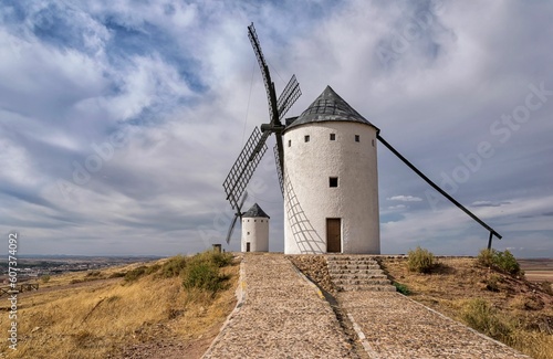 Row of white ad black windmills in Castilla La Manha village Spain