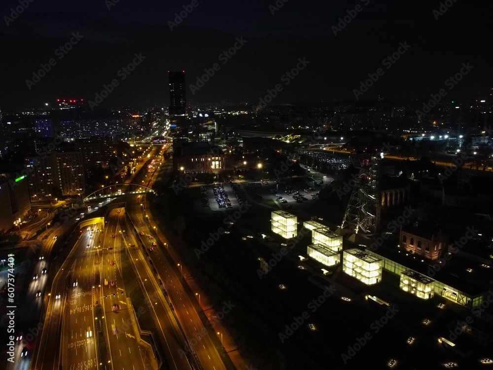 Aerial shot of roads in the middle of city buildings at night in Katowice, Poland