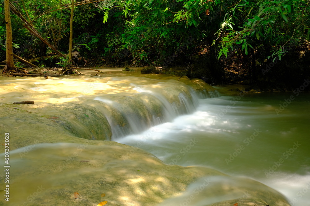 Obraz premium Waterfall flowing in the forest during the rainy season Namtok Wang Kan Lueang, Lop Buri