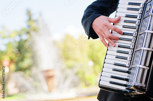 Foto Accordion. Keys. Male hand on the accordion.