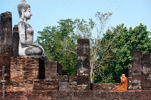 Budhism in asia. Budhist monk praying in budhist temple.