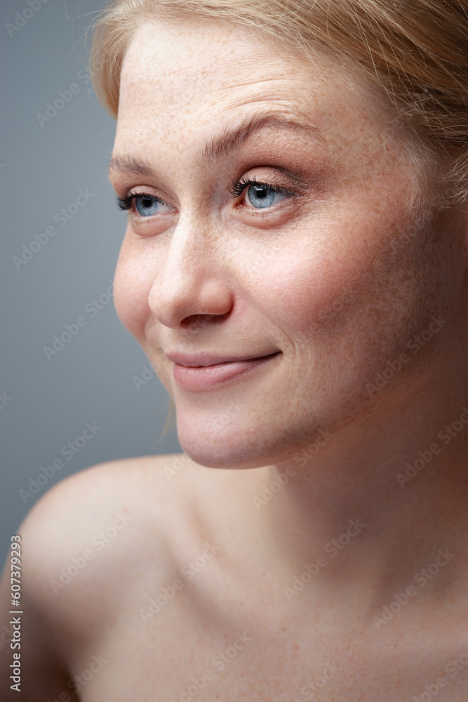 Natural beauty. Close-up studio portrait of a young woman with naked shoulders