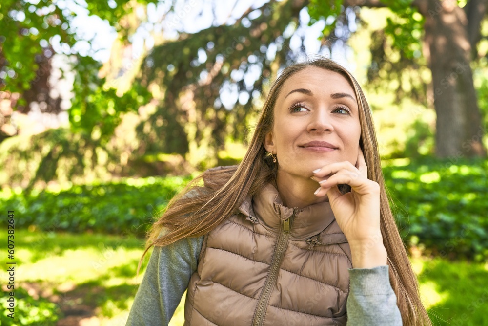 Seizing the day, her smile to the camera radiates joy in the park. Seizing the day, her smile to the camera radiates joy in the park.
