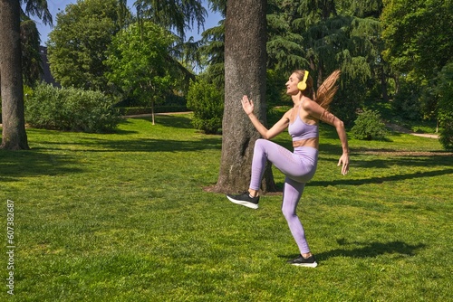 In sportswear  a woman in the park warms up  her commitment to fitness clear.