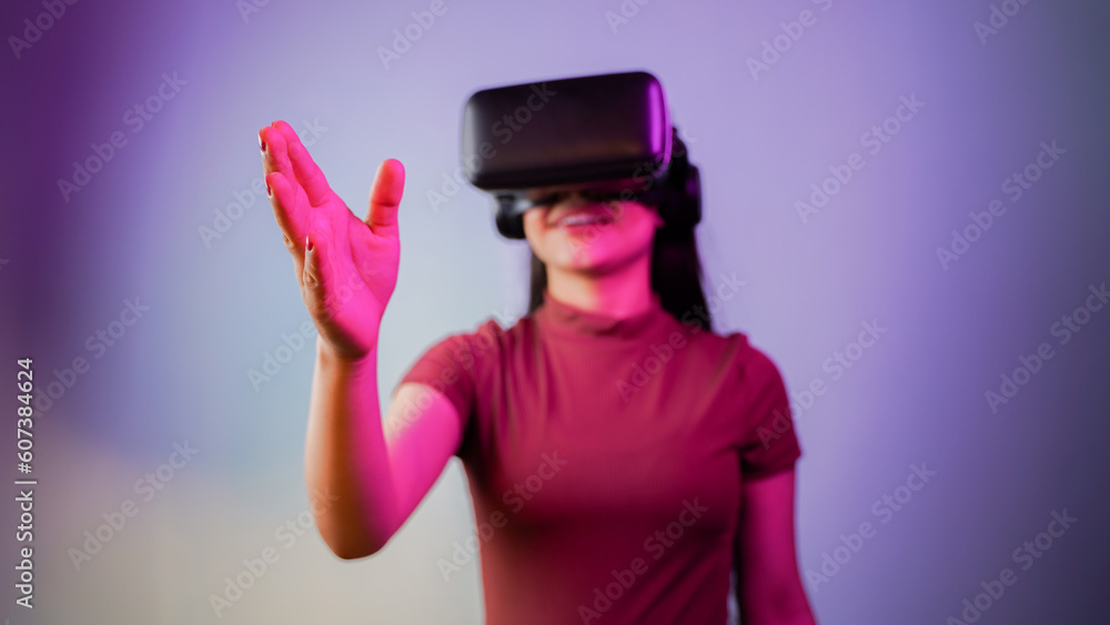 Cheerful young Asian Indian woman wearing a virtual reality headset, girl with vr glasses concept studio portrait Cheerful young Asian Indian woman wearing a virtual reality headset, girl with vr glasses concept studio portrait
