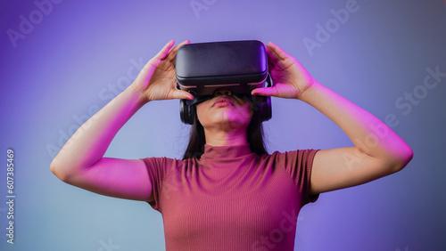 Young Asian Indian woman wearing virtual reality headset, a girl with VR glasses concept studio portrait