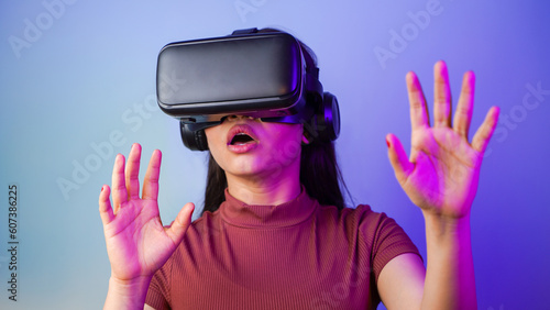 Surprised young Asian Indian woman wearing a virtual reality headset, a shocked girl with vr glasses concept studio portrait © Arnav Pratap Singh
