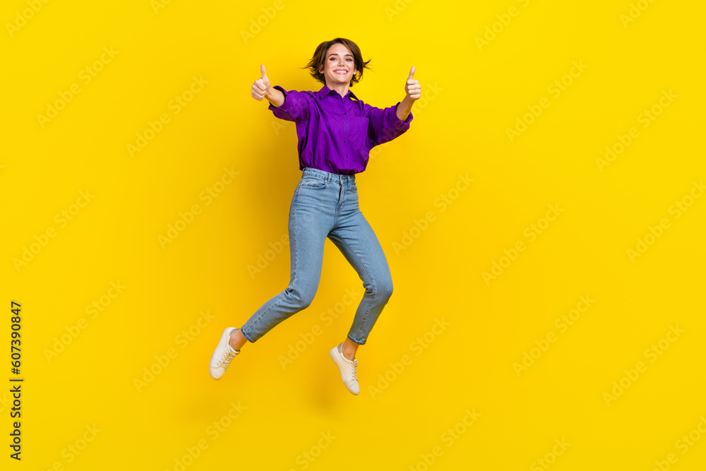 Full body photo of young marketer lady brown bob hair thumbs up jump wear violet shirt rate new office isolated on yellow color background Full body photo of young marketer lady brown bob hair thumbs up jump wear violet shirt rate new office isolated on yellow color background