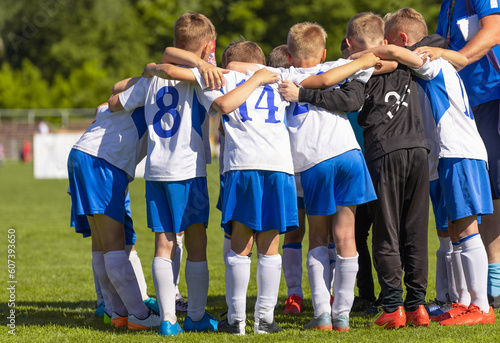 Group of Teenage Boys in Sports Team. Boys Huddling in a Circle with Coach Before the Tournament Game