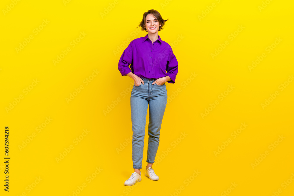 Fototapeta premium Full body photo of cheerful businesswoman wear violet shirt denim jeans posing for magazine formal clothes isolated on yellow background