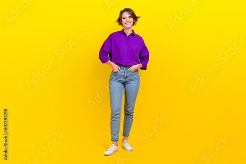 Full body photo of cheerful businesswoman wear violet shirt denim jeans posing for magazine formal clothes isolated on yellow background