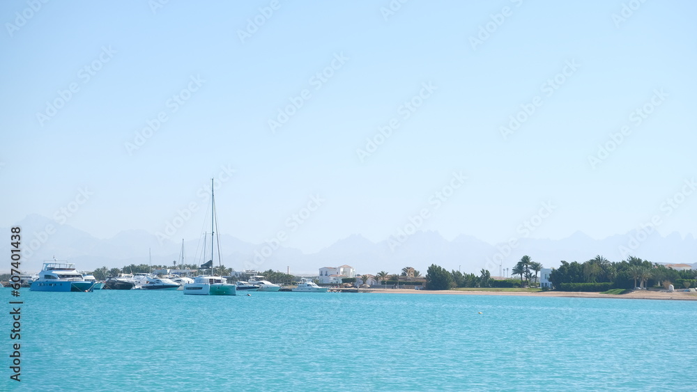 Serenity Unveiled: A Mesmerizing Sunset at Sea with Graceful Boats Amidst the Golden Hues, an Enchanting Moment of Tranquility and Nautical Beauty in Hurghada , El gouna , Egypt 