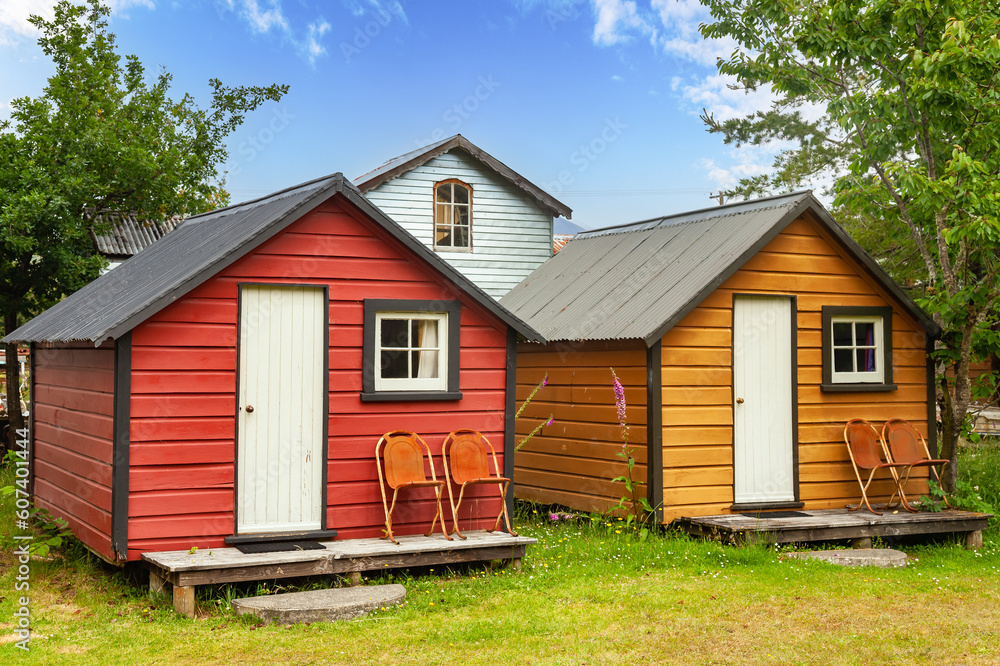 Wooden camping cabins at a campsite in New Zealand Wooden camping cabins at a campsite in New Zealand