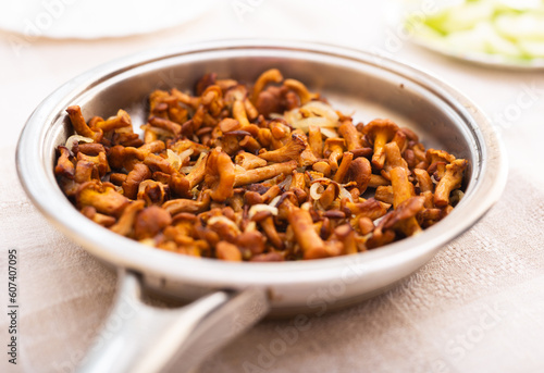 delicious forest mushrooms chanterelles fried in frying pan