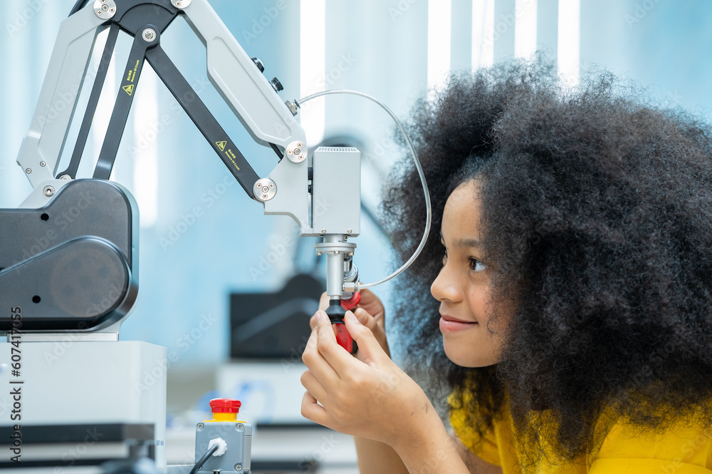 Machine Learning Robotics Class Kid female teen child enjoy Machine Learning Robot arm is Moving Under ...