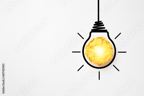 Yellow scrap paper ball with illustration painting for virtual lightbulb. It is creative thinking idea for problem solving and innovation concept.