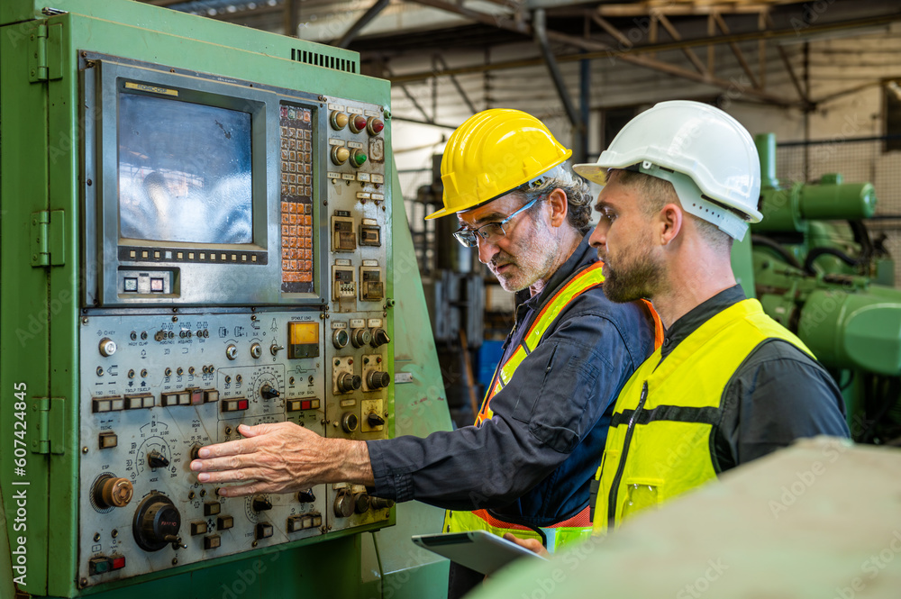 Two professional engineer worker technician assistant in helmet inspection check old machine construction factory with colleague manager. check old machinery production construction operating Two professional engineer worker technician assistant in helmet inspection check old machine construction factory with colleague manager. check old machinery production construction operating