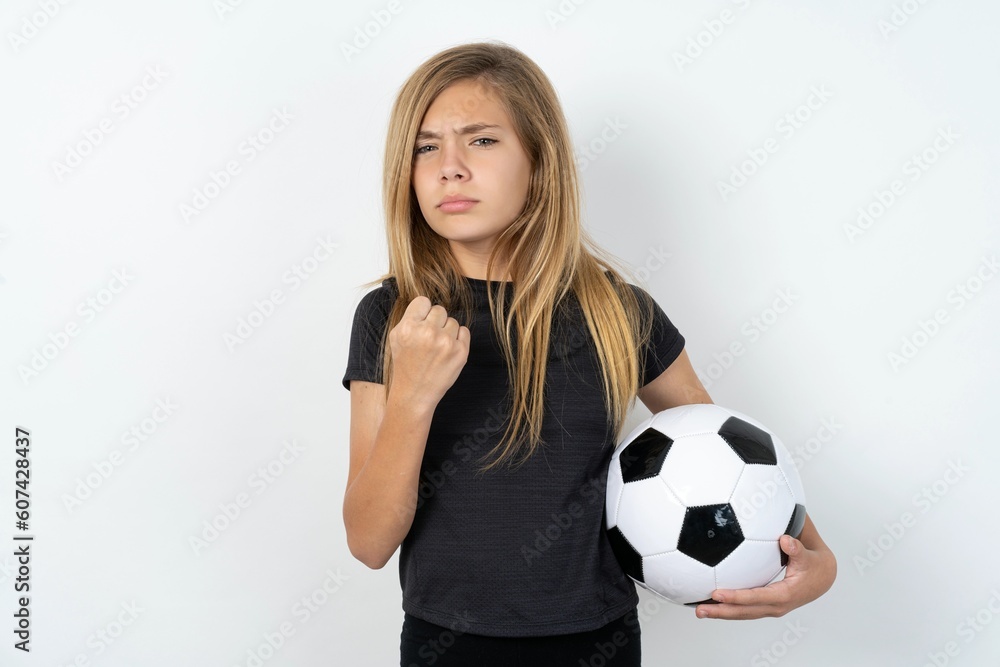 beautiful caucasian teen girl wearing sportswear over white wall shows fist has annoyed face expression going to revenge or threaten someone makes serious look. I will show you who is boss beautiful caucasian teen girl wearing sportswear over white wall shows fist has annoyed face expression going to revenge or threaten someone makes serious look. I will show you who is boss