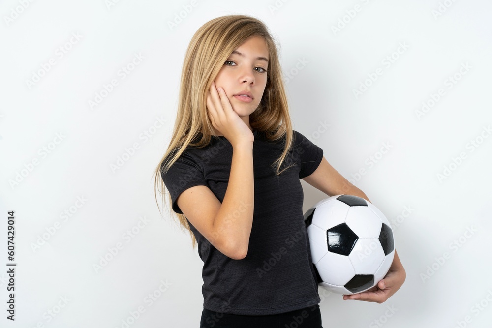 Photo of beautiful caucasian teen girl wearing sportswear over white wall enjoy fresh perfect smooth skin touch face Photo of beautiful caucasian teen girl wearing sportswear over white wall enjoy fresh perfect smooth skin touch face