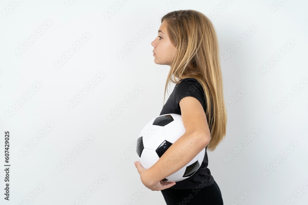 Profile portrait of nice beautiful caucasian teen girl wearing sportswear over white wall look empty space toothy smile Profile portrait of nice beautiful caucasian teen girl wearing sportswear over white wall look empty space toothy smile