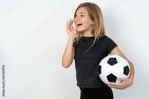 beautiful caucasian teen girl wearing sportswear  over white wall look empty space holding hand face and screaming or calling someone.