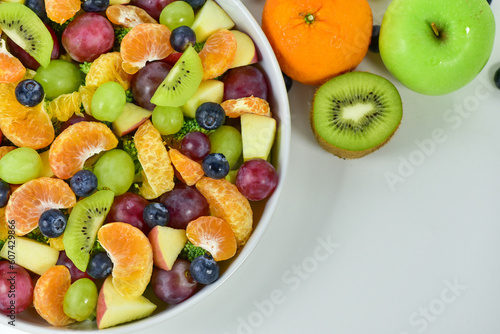 Healthy fresh fruit salad bowl on white background. Top view. Healthy food concept  healthy high vitamin fruit  mixed fruit background.